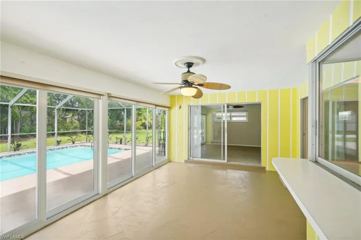 Enclosed Florida room that opens to pool or closed to stay warm. Has Coolaroo shades