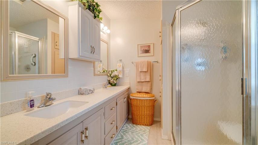 Corian-like counter top, matching backsplash, well-maintained cabinetry, and a stand-alone shower. This ensuite is perfect!