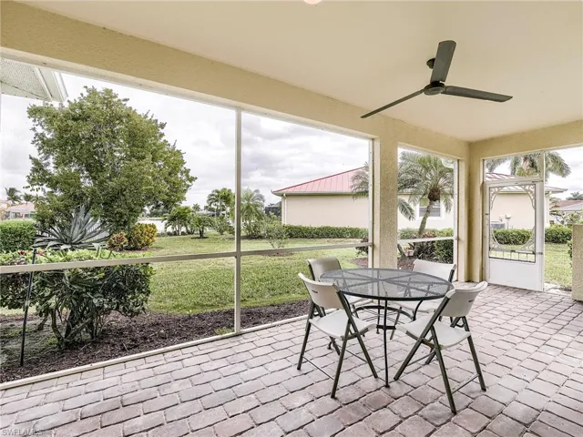 Sunroom with outdoor dining area and a ceiling fan