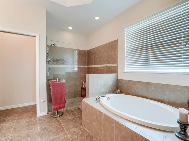 Full bathroom with a bath, light tile patterned flooring, a stall shower, and recessed lighting
