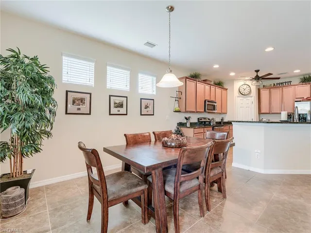 Dining room with a ceiling fan, recessed lighting, and light tile patterned floors