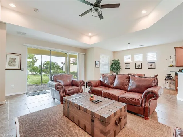 Living room featuring light tile patterned flooring, plenty of natural light, ceiling fan, and recessed lighting