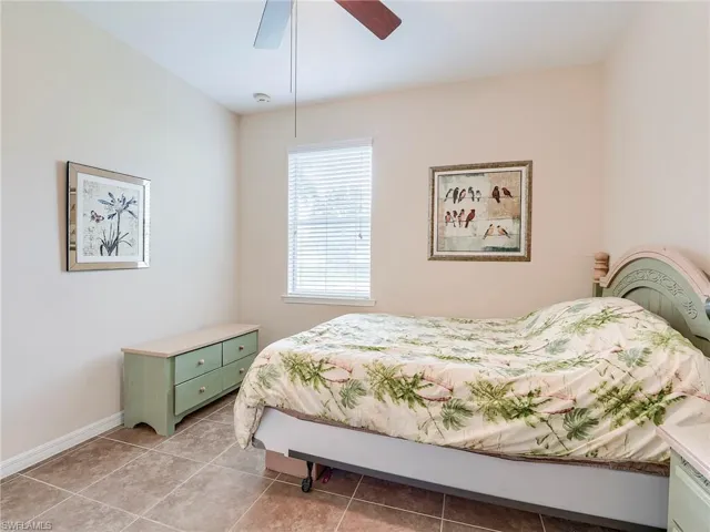 Bedroom featuring a ceiling fan and light tile patterned flooring