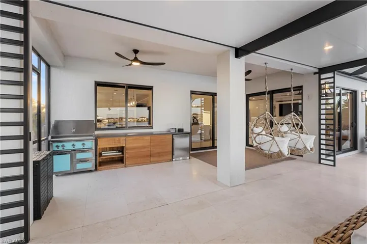 View of patio with a ceiling fan and grilling area