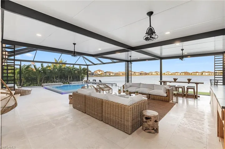 View of patio / terrace featuring an outdoor pool, a residential view, a lanai, an outdoor lounge area, and a sunroom