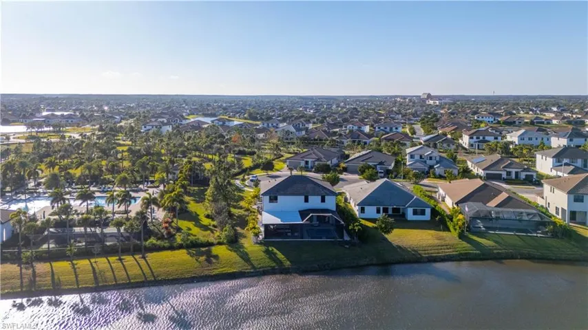 Aerial view of residential area featuring a nearby body of water