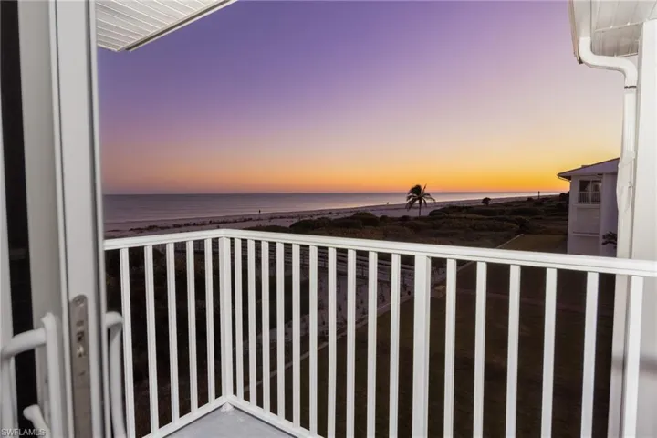 Balcony with view of water and beach
