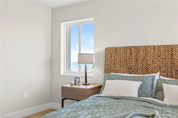 Bedroom featuring wood finished floors and a water view