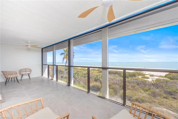 Sunroom / solarium with expansive windows and a water view