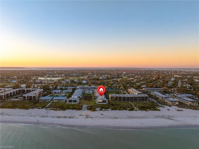 Aerial view at dusk of view of water and beach