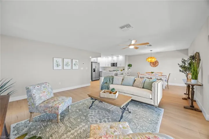 Living room with light wood finished floors and a ceiling fan