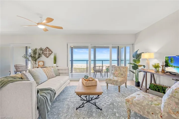 Living area featuring ceiling fan and wood finished floors
