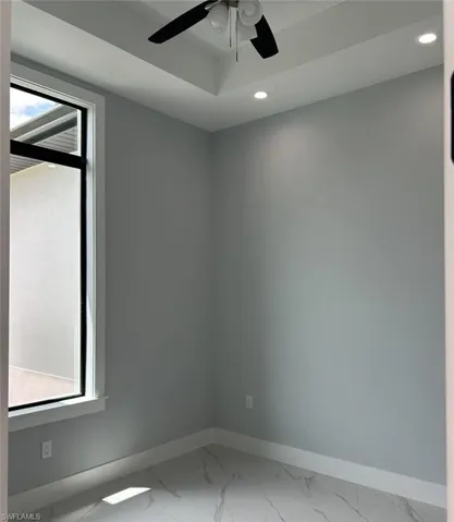 Unfurnished room with ceiling fan and tile "Den"