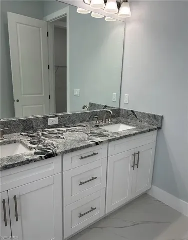 Bathroom with tile patterned flooring and vanity