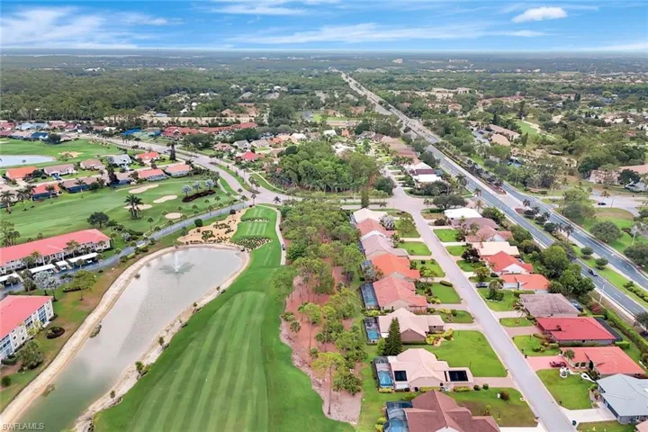 Aerial view of residential area with a large body of water and a golf course