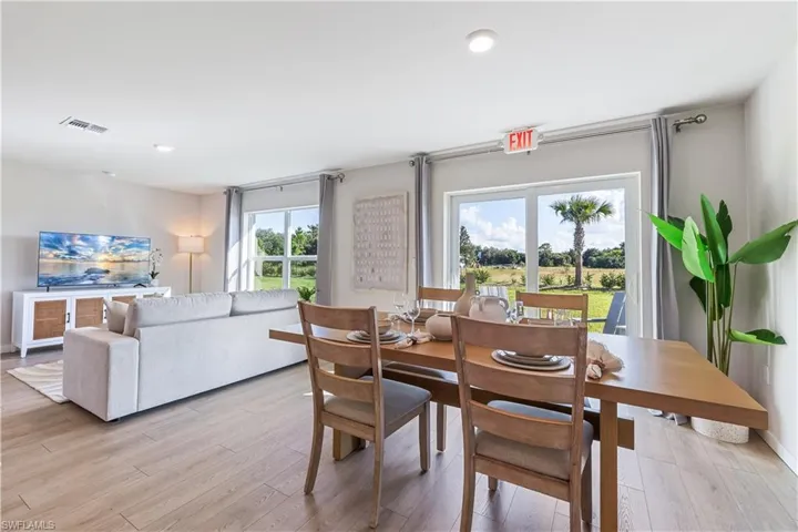 MODEL HOME - Dining area featuring light wood finished floors and recessed lighting