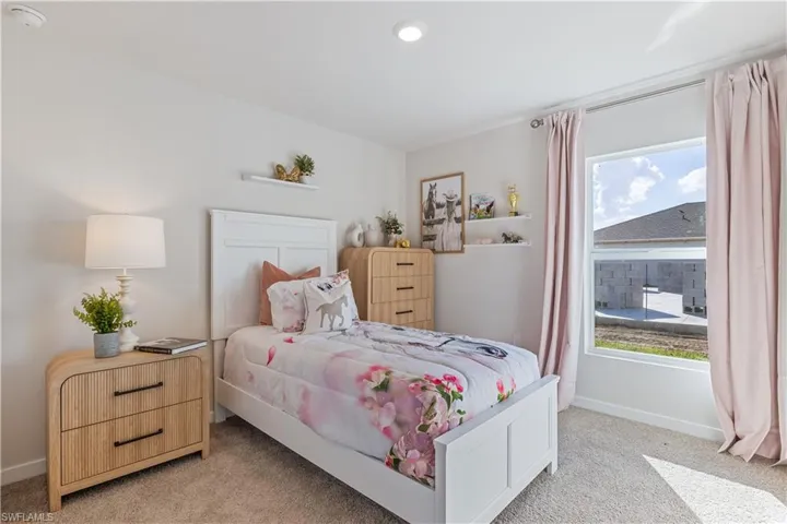 MODEL HOME - Carpeted bedroom featuring baseboards