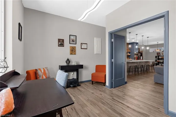 Home office with light wood-style floors and baseboards
