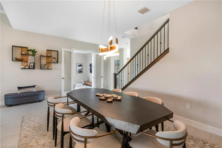 Dining area with baseboards and stairway