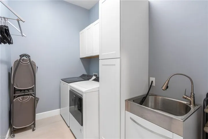 Laundry room with cabinet space and washing machine and dryer