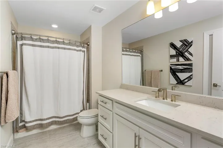 Bathroom with vanity and shower / bath combo
