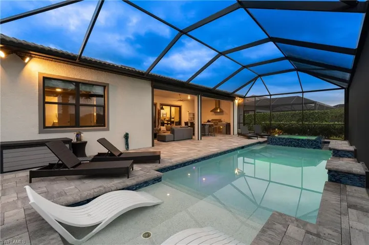 View of swimming pool, a lanai, a patio, and a pool with connected hot tub