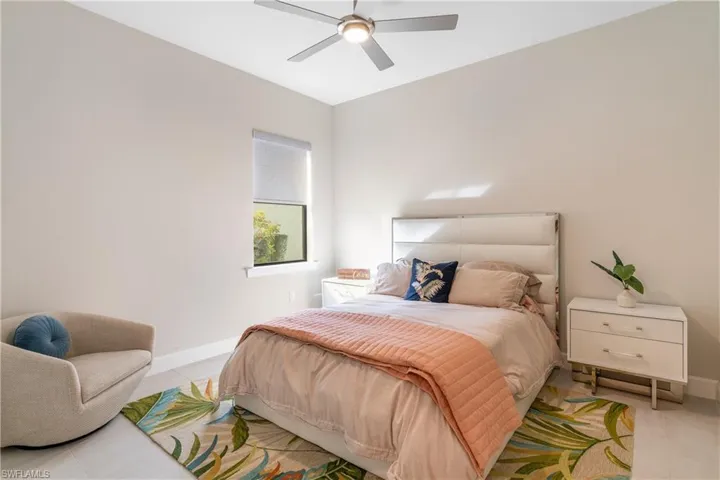 Bedroom with a ceiling fan and tile patterned floors