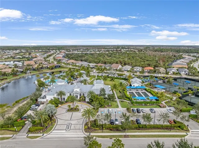 Aerial view of residential area featuring a nearby body of water
