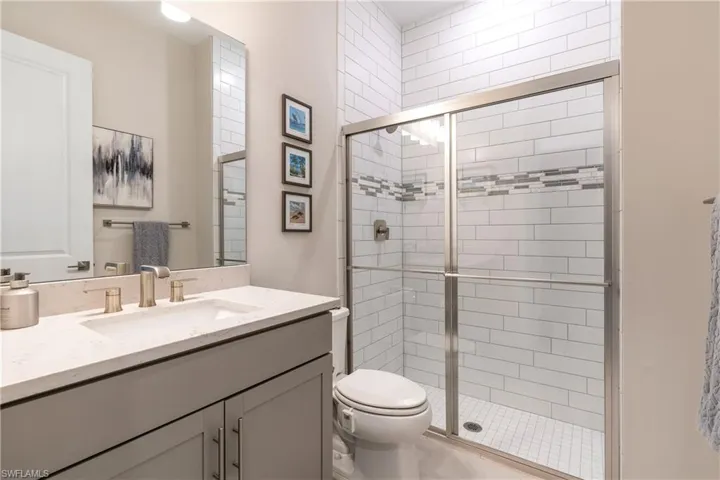 Bathroom featuring vanity and a stall shower