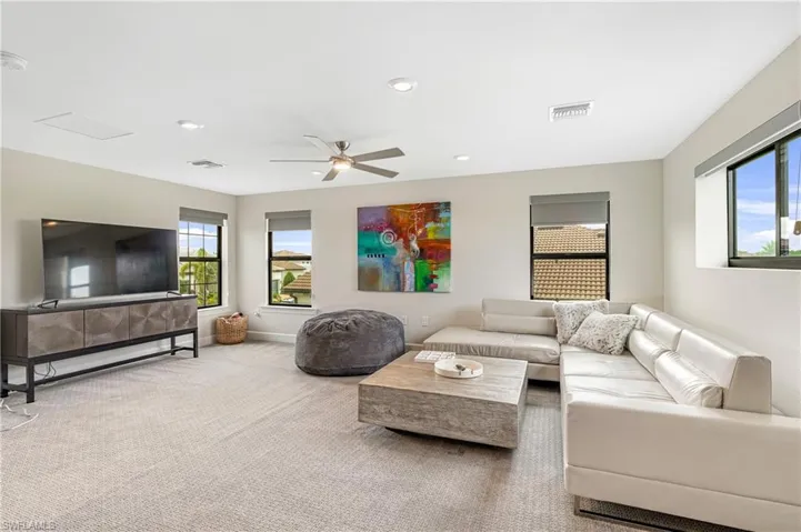 Living area with recessed lighting, ceiling fan, and carpet floors