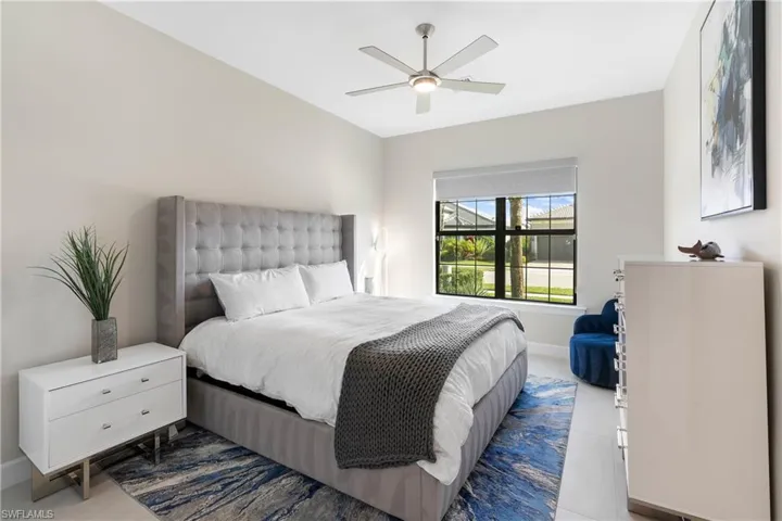 Bedroom with a ceiling fan and baseboards