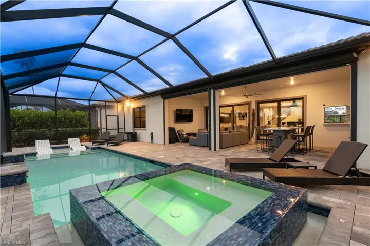 View of pool featuring  a lanai, a patio area, and a pool with connected hot tub