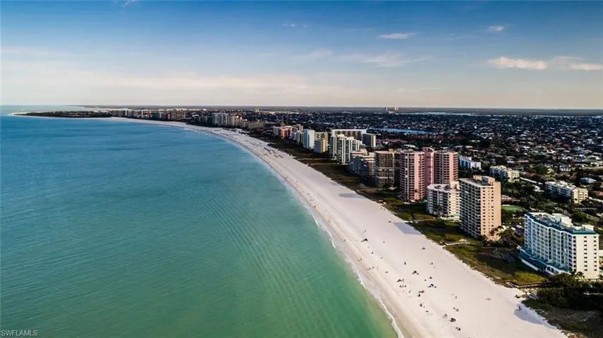 Birds eye view of property with a view of the beach and a water view