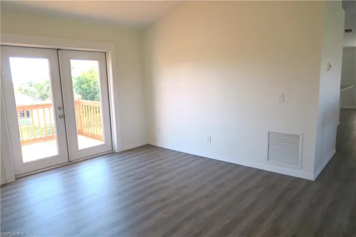 Spare room featuring wood finished floors and french doors