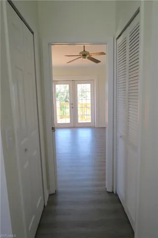 Corridor featuring dark wood-style floors