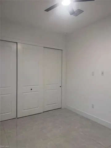 Unfurnished bedroom featuring a closet and a ceiling fan