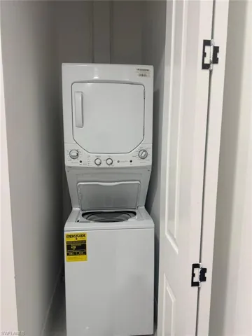 Washroom featuring estacked washer and dryer