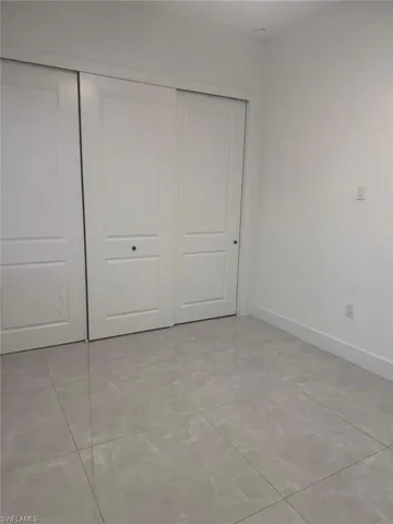 Unfurnished bedroom featuring a closet and light tile patterned floors