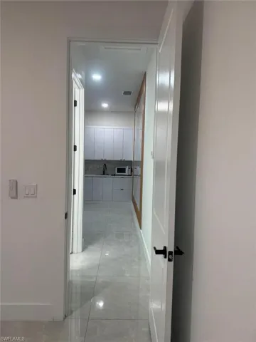 Hall with baseboards and recessed lighting