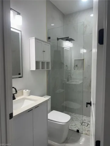 Full bathroom featuring vanity and a stall shower