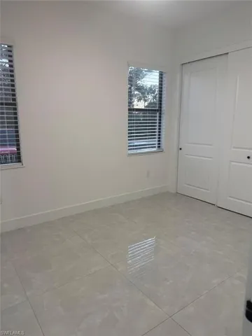 Unfurnished bedroom featuring a closet and light tile patterned flooring