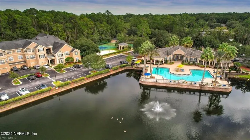 Birds eye view of property with a water view