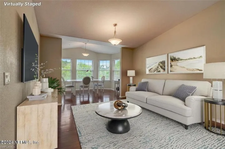 Living room featuring lofted ceiling and hardwood / wood-style floors