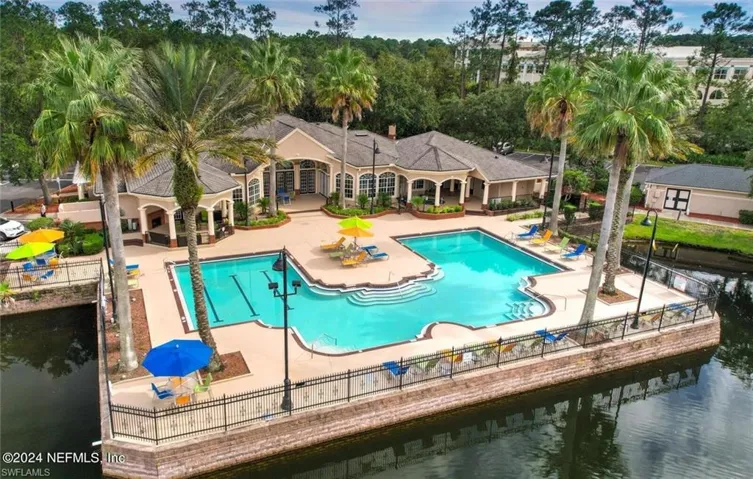 View of pool with a water view and a patio area