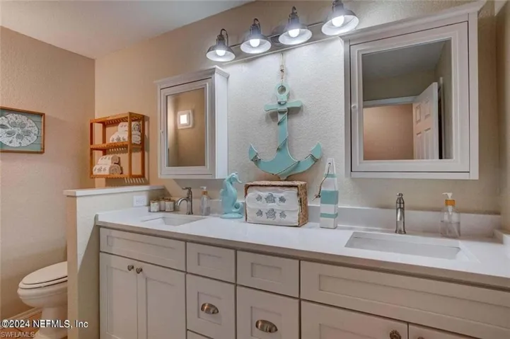 Bathroom with toilet and double vanity