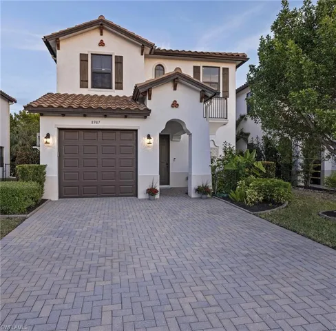 Mediterranean / spanish house with a garage and a balcony