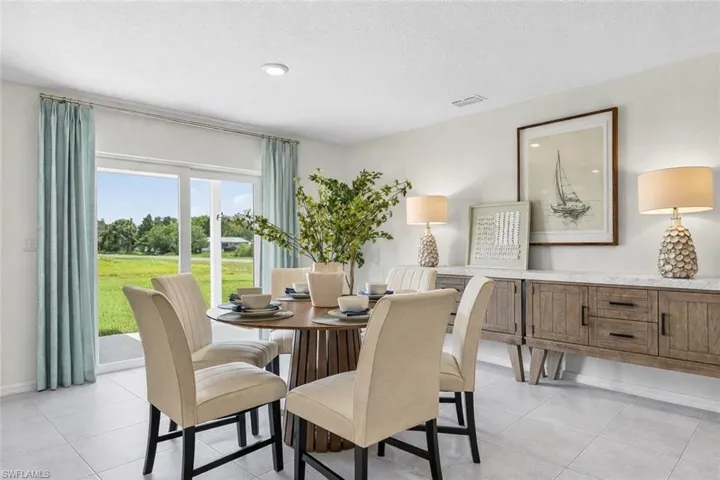 Dining area with light tile patterned floors and a textured ceiling