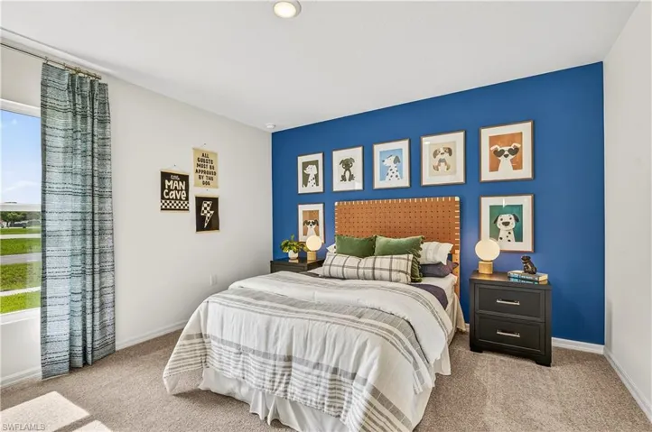 Bedroom featuring light colored carpet