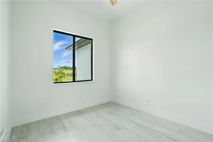 Spare room with wood finished floors and a ceiling fan