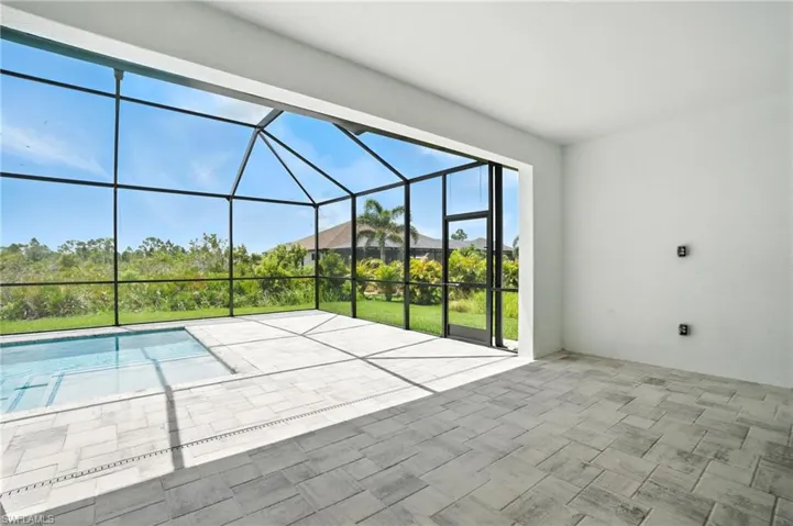 View of patio featuring glass enclosure and an outdoor pool